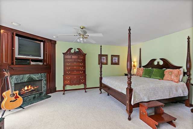 1606 Gregden Shores Dr, Sterling, IL 61081 - bedroom with light carpet, a fireplace, and ceiling fan
