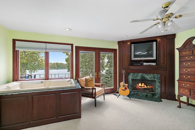 1606 Gregden Shores Dr, Sterling, IL 61081 - living area featuring light colored carpet, a high end fireplace, french doors, and ceiling fan