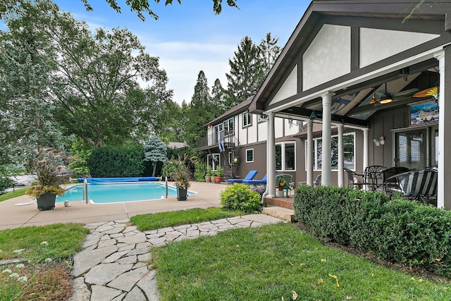 1606 Gregden Shores Dr, Sterling, IL 61081 - view of pool featuring a patio, a covered pool, a ceiling fan, and a lawn