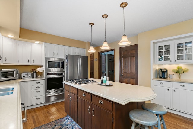 1606 Gregden Shores Dr, Sterling, IL 61081 - kitchen featuring stainless steel appliances, a warming drawer, light wood-type flooring, and light countertops