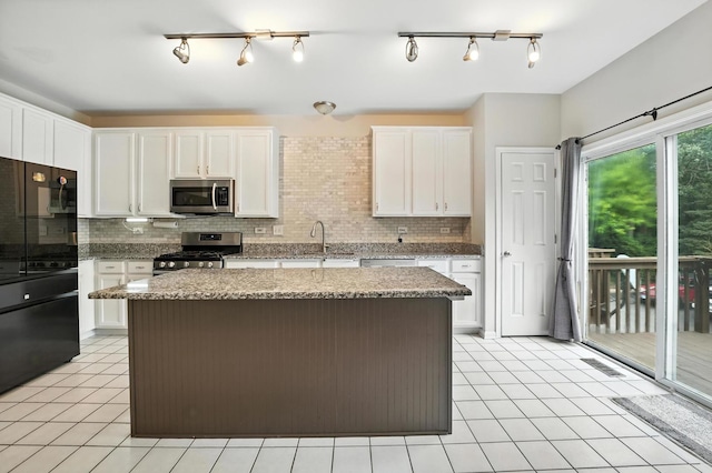 186 Willow Blvd, Willow Springs, IL 60480 - kitchen with stainless steel appliances, backsplash, a kitchen island, and white cabinets