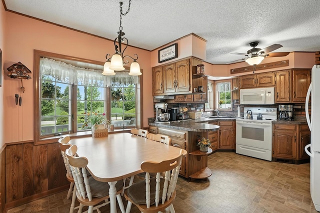 28457 S Yates Ave, Beecher, IL 60401 - kitchen with white appliances, brown cabinetry, dark countertops, and a textured ceiling