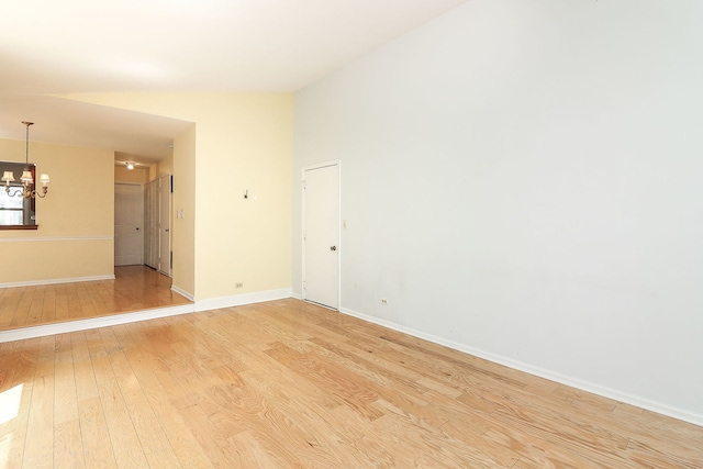 1918 N Yale Ave, Arlington Heights, IL 60004 - spare room with a chandelier, light wood-style flooring, and lofted ceiling