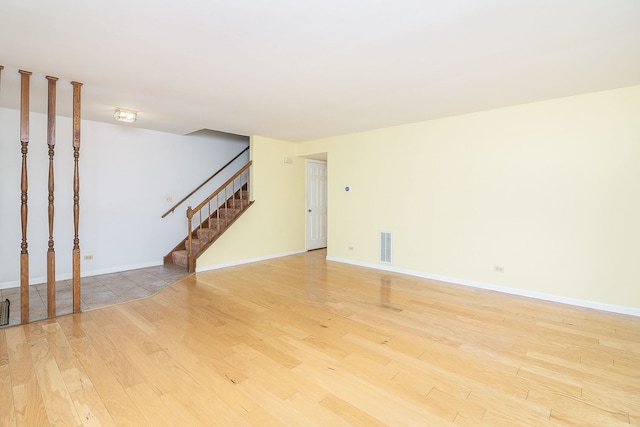 1918 N Yale Ave, Arlington Heights, IL 60004 - unfurnished living room with light wood-style floors and stairway