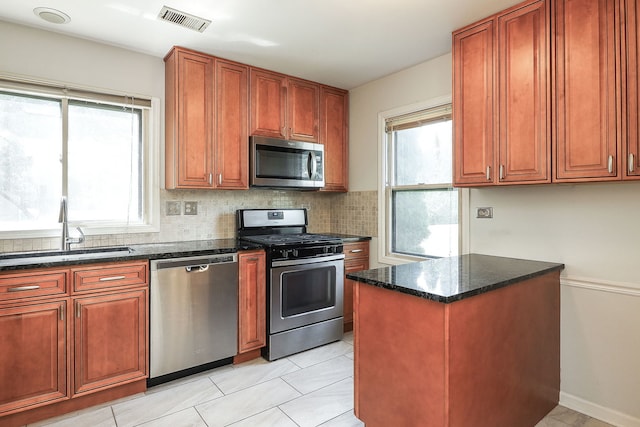 1918 N Yale Ave, Arlington Heights, IL 60004 - kitchen with appliances with stainless steel finishes, tasteful backsplash, dark stone counters, and light tile patterned floors
