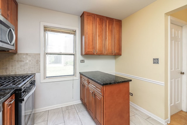 1918 N Yale Ave, Arlington Heights, IL 60004 - kitchen with stainless steel microwave, gas stove, dark stone countertops, and brown cabinets