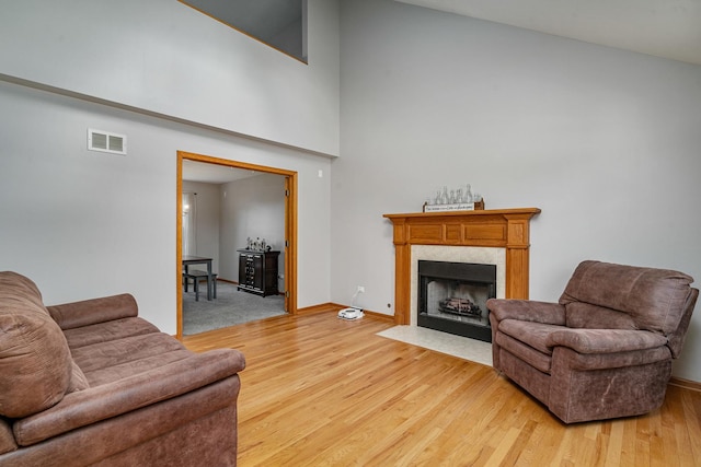 5505 Salma St, Plainfield, IL 60586 - living area with light wood-type flooring, a high end fireplace, and a high ceiling