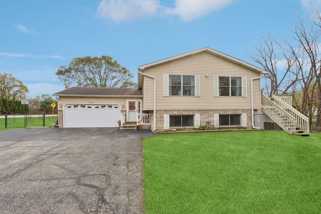9997 W Paddock Ave, Beach Park, IL 60087 - tri-level home featuring asphalt driveway, a garage, stairway, and brick siding