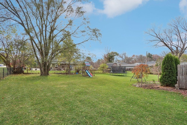 9997 W Paddock Ave, Beach Park, IL 60087 - fenced backyard featuring a trampoline and a playground