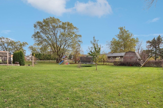 9997 W Paddock Ave, Beach Park, IL 60087 - view of grassy yard with a trampoline, a playground, and a barn
