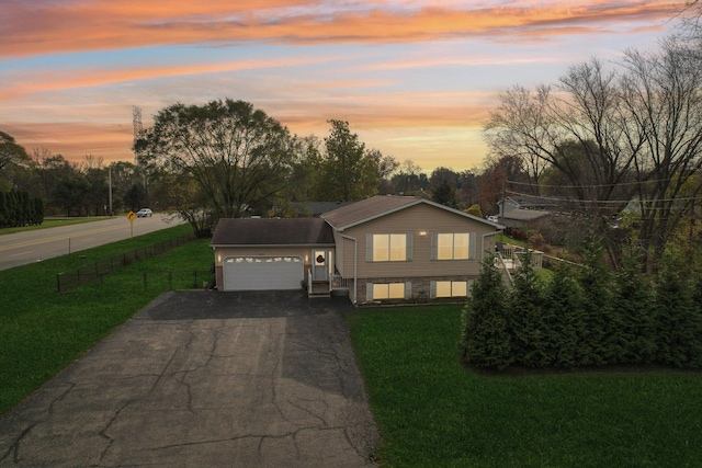 9997 W Paddock Ave, Beach Park, IL 60087 - split level home with asphalt driveway, an attached garage, and view of scattered trees