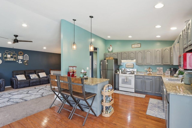 9997 W Paddock Ave, Beach Park, IL 60087 - kitchen featuring white gas range oven, gray cabinetry, freestanding refrigerator, open floor plan, and light wood finished floors