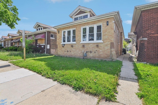 7930 S Kenwood Ave, Chicago, IL 60619 - bungalow-style home with brick siding and a front lawn