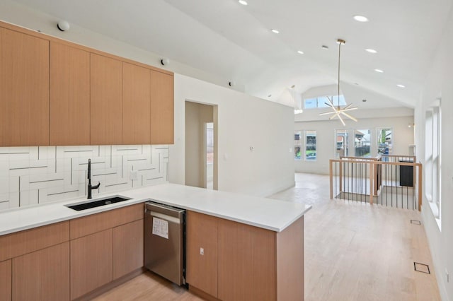 7930 S Kenwood Ave, Chicago, IL 60619 - kitchen with stainless steel dishwasher, open floor plan, a peninsula, backsplash, and vaulted ceiling