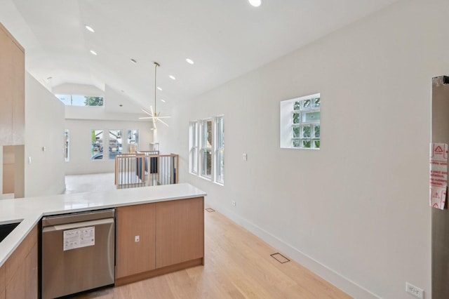 7930 S Kenwood Ave, Chicago, IL 60619 - kitchen featuring stainless steel dishwasher, vaulted ceiling, light wood-style floors, light countertops, and a peninsula