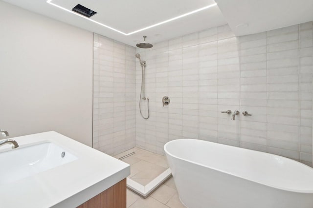 7930 S Kenwood Ave, Chicago, IL 60619 - full bath featuring tiled shower, a soaking tub, tile patterned flooring, and vanity