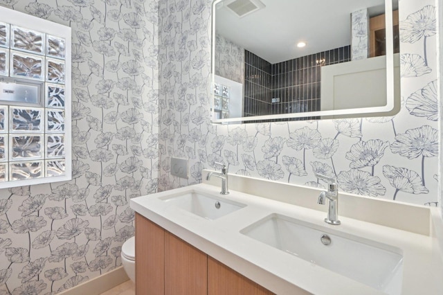 7930 S Kenwood Ave, Chicago, IL 60619 - full bathroom featuring double vanity, wallpapered walls, and recessed lighting