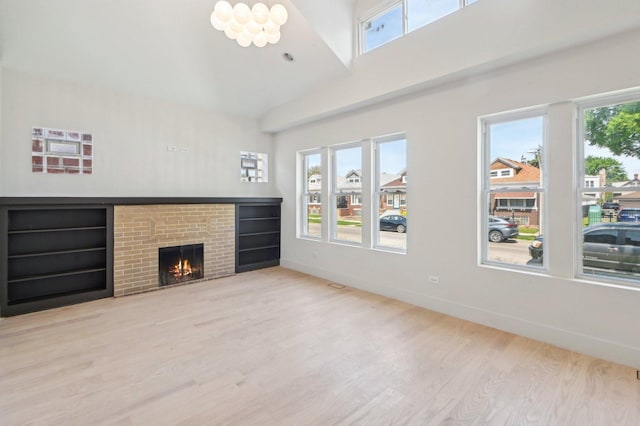 7930 S Kenwood Ave, Chicago, IL 60619 - unfurnished living room with wood finished floors, a high ceiling, and a brick fireplace