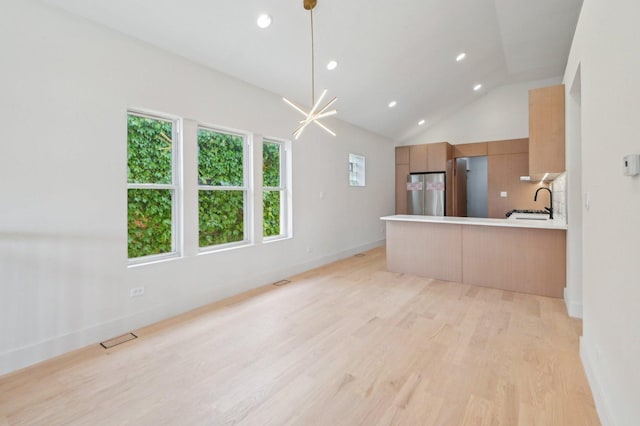 7930 S Kenwood Ave, Chicago, IL 60619 - unfurnished living room featuring light wood-style flooring, vaulted ceiling, and recessed lighting
