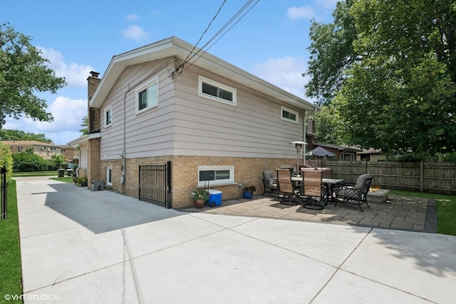 1308 Hoffman Ave, Park Ridge, IL 60068 - back of house featuring a patio area, a chimney, and brick siding