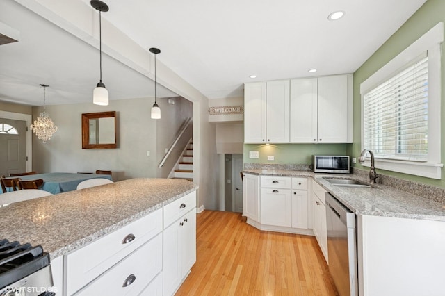 1308 Hoffman Ave, Park Ridge, IL 60068 - kitchen with stainless steel appliances, light wood-style floors, healthy amount of natural light, white cabinetry, and recessed lighting