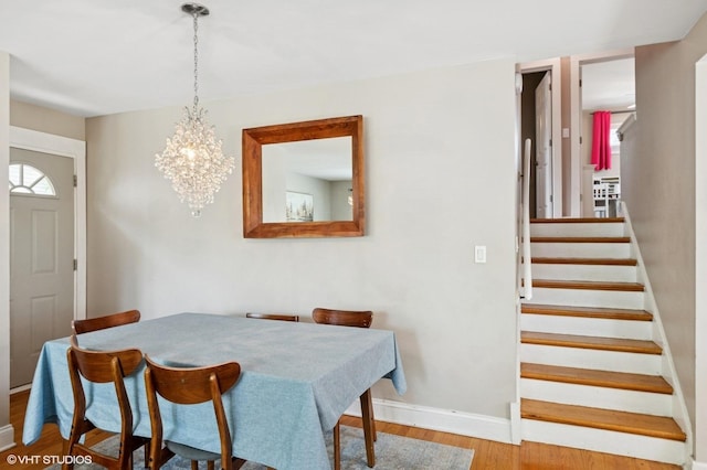 1308 Hoffman Ave, Park Ridge, IL 60068 - dining area with wood finished floors, a chandelier, and stairs