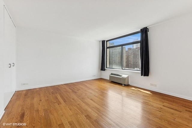 1450 N Astor St Unit 14D, Chicago, IL 60610 - unfurnished room featuring light wood-style floors and an AC wall unit