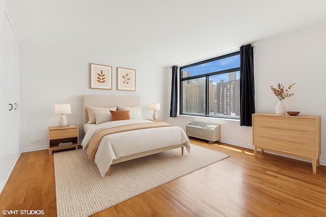 1450 N Astor St Unit 14D, Chicago, IL 60610 - bedroom featuring wood finished floors and a wall mounted air conditioner