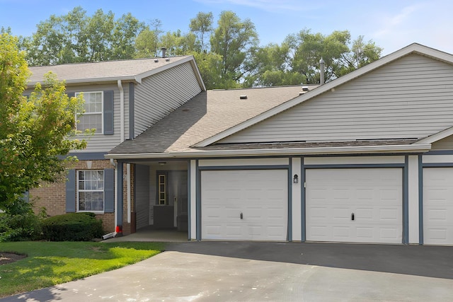 992 Langtry Ct Unit D, Elgin, IL 60120 - view of front of property featuring a shingled roof, an attached garage, driveway, and brick siding