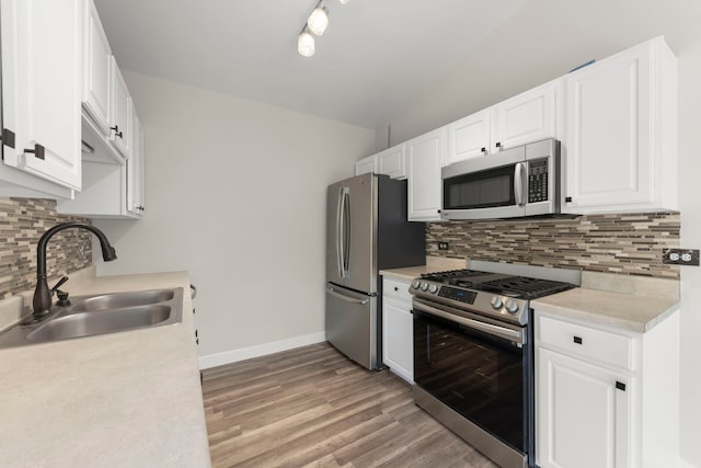 992 Langtry Ct Unit D, Elgin, IL 60120 - kitchen with stainless steel appliances, light countertops, white cabinetry, tasteful backsplash, and lofted ceiling
