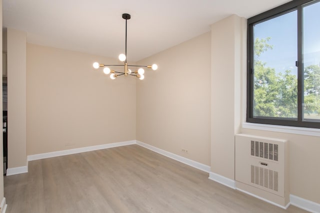 1110 Grove St Unit 4A, Downers Grove, IL 60515 - unfurnished room with a chandelier and light wood-style floors