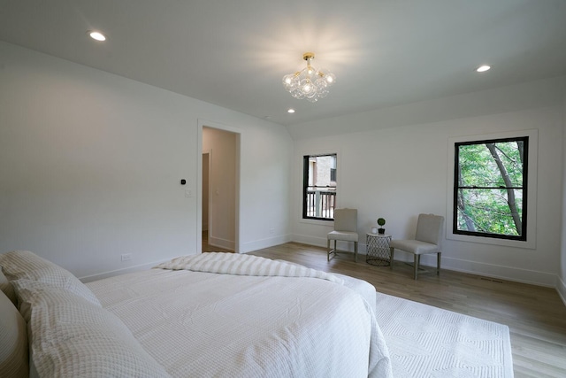 1332 N Leavitt St, Chicago, IL 60622 - bedroom featuring multiple windows, light wood finished floors, a chandelier, and recessed lighting
