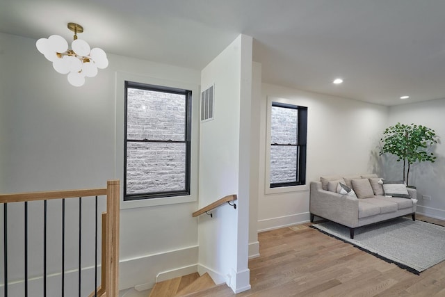 1332 N Leavitt St, Chicago, IL 60622 - living area with light wood finished floors, a chandelier, an upstairs landing, recessed lighting, and plenty of natural light