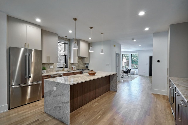 1332 N Leavitt St, Chicago, IL 60622 - kitchen featuring high end refrigerator, a kitchen island, backsplash, light wood-style floors, and recessed lighting