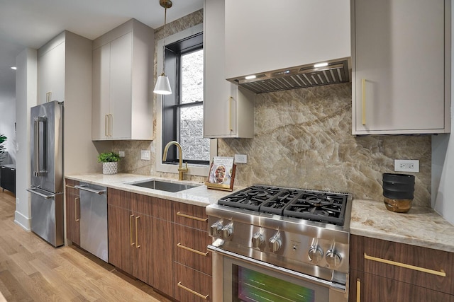 1332 N Leavitt St, Chicago, IL 60622 - kitchen featuring high end appliances, light wood-style floors, light stone countertops, decorative light fixtures, and tasteful backsplash