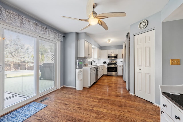 2706 Steamboat Cir, Plainfield, IL 60586 - kitchen featuring stainless steel appliances, white cabinetry, ceiling fan, and dark wood finished floors