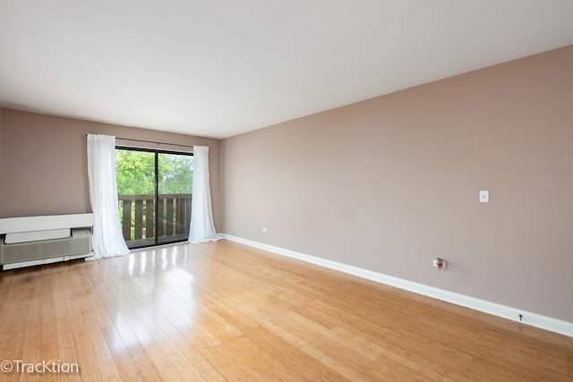 1091 Rodenburg Rd Unit 303, Roselle, IL 60172 - unfurnished living room with light wood-type flooring and baseboards