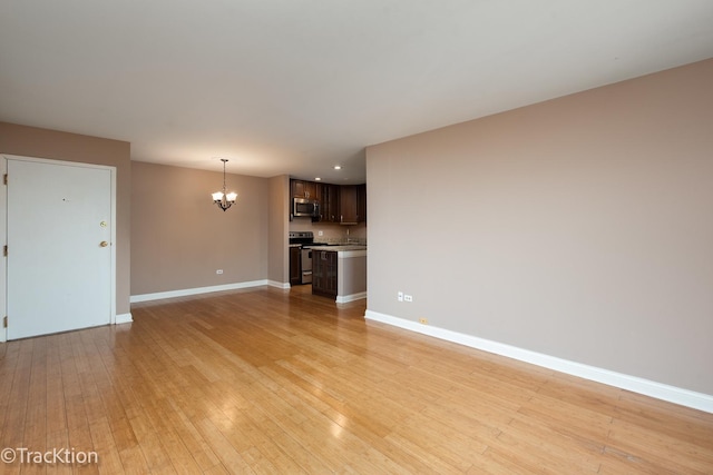 1091 Rodenburg Rd Unit 303, Roselle, IL 60172 - unfurnished living room featuring a chandelier, light wood-style floors, and recessed lighting
