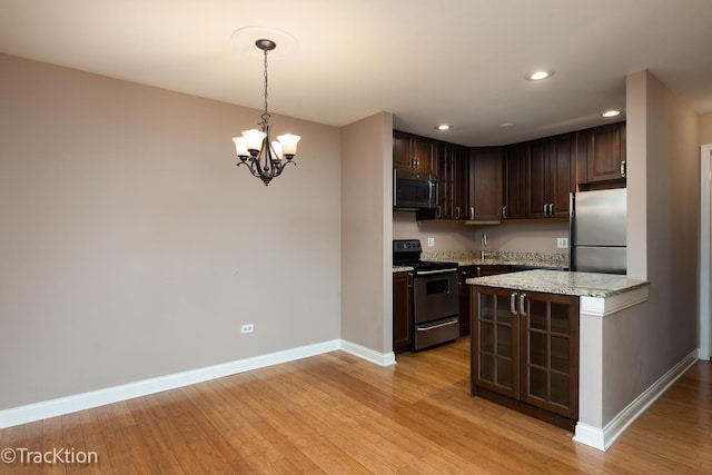 1091 Rodenburg Rd Unit 303, Roselle, IL 60172 - kitchen with appliances with stainless steel finishes, dark brown cabinetry, recessed lighting, a chandelier, and light wood-style flooring