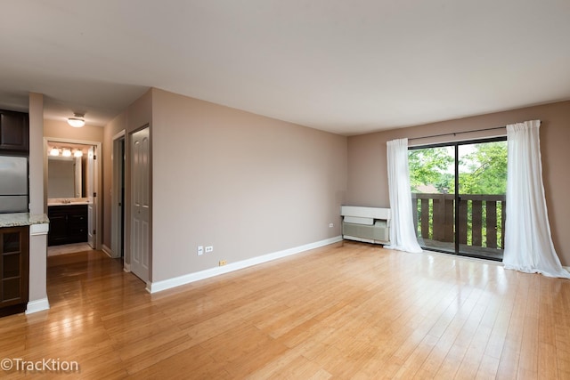 1091 Rodenburg Rd Unit 303, Roselle, IL 60172 - unfurnished room featuring light wood finished floors and baseboards