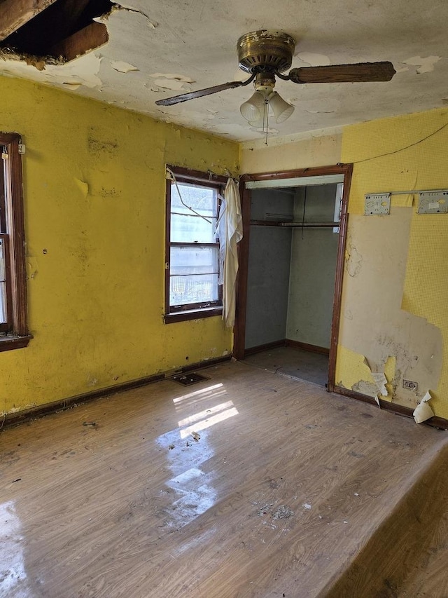 10511 S Yates Ave, Chicago, IL 60617 - unfurnished bedroom with wood finished floors, a ceiling fan, and a closet