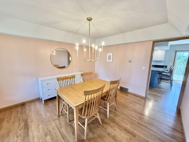 5448 S Branch Ct, Rochelle, IL 61068 - dining room with light wood-style floors and a chandelier