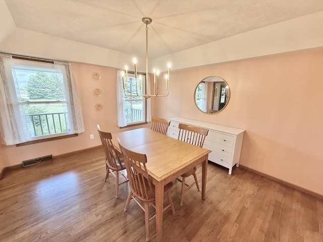 5448 S Branch Ct, Rochelle, IL 61068 - dining space with light wood-style floors and a chandelier