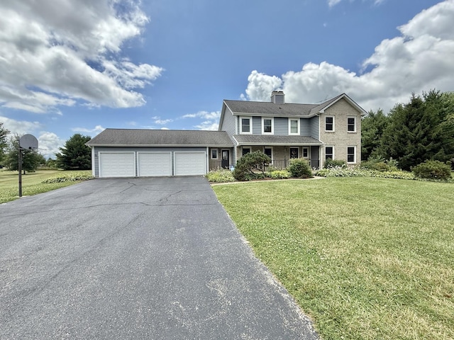 5448 S Branch Ct, Rochelle, IL 61068 - traditional home featuring asphalt driveway, a chimney, an attached garage, and a front lawn