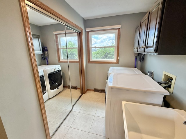 5448 S Branch Ct, Rochelle, IL 61068 - washroom featuring washing machine and clothes dryer, cabinet space, and light tile patterned floors