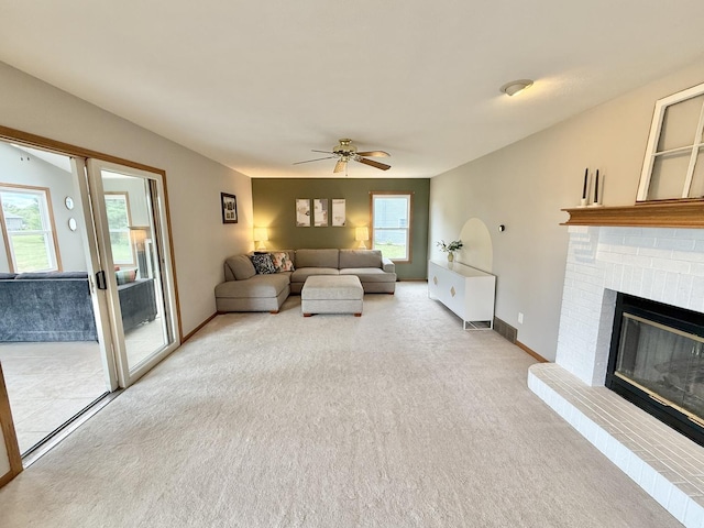 5448 S Branch Ct, Rochelle, IL 61068 - living area featuring light carpet, a ceiling fan, and a fireplace