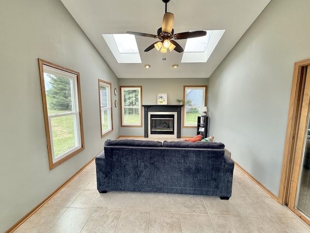 5448 S Branch Ct, Rochelle, IL 61068 - living area with a skylight, lofted ceiling, light tile patterned floors, a glass covered fireplace, and a ceiling fan