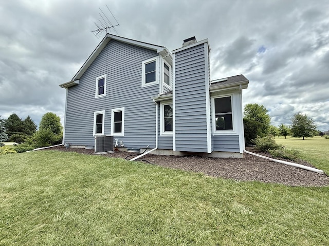 5448 S Branch Ct, Rochelle, IL 61068 - rear view of property with a chimney and a lawn