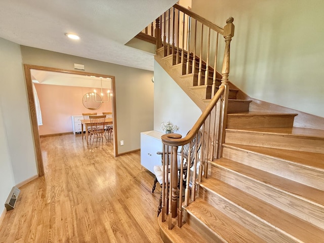 5448 S Branch Ct, Rochelle, IL 61068 - stairway with a chandelier, wood finished floors, and recessed lighting