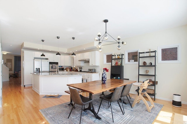 1215 W 33rd St, Chicago, IL 60608 - dining space featuring light wood-style flooring and a chandelier
